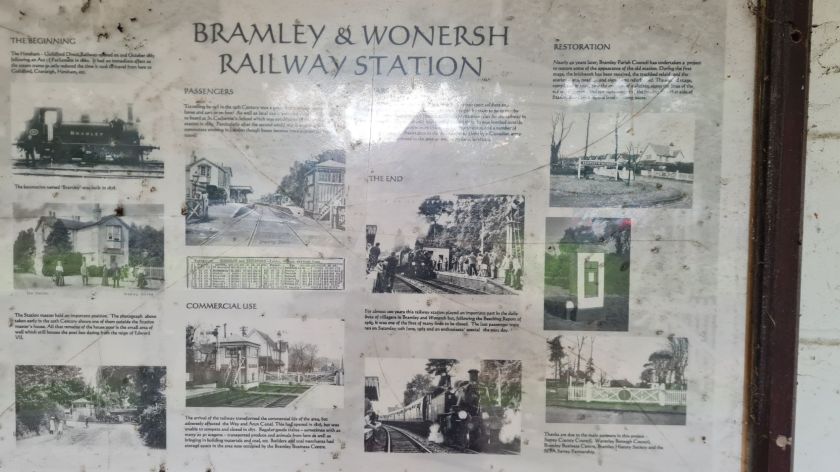 An information board with images, telling the history of Bramley & Wonersh station.