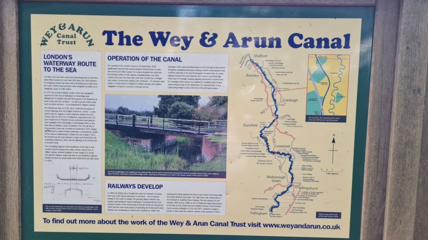 Information board on the history and route of the Wey and Arun Canal, which runs parallel to much of the old line.
